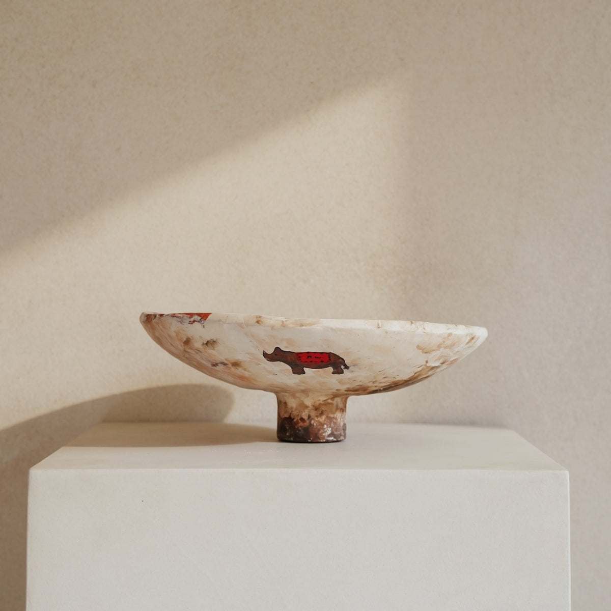 Hand-crafted from natural clays and plaster with drawings of baby rhinos.