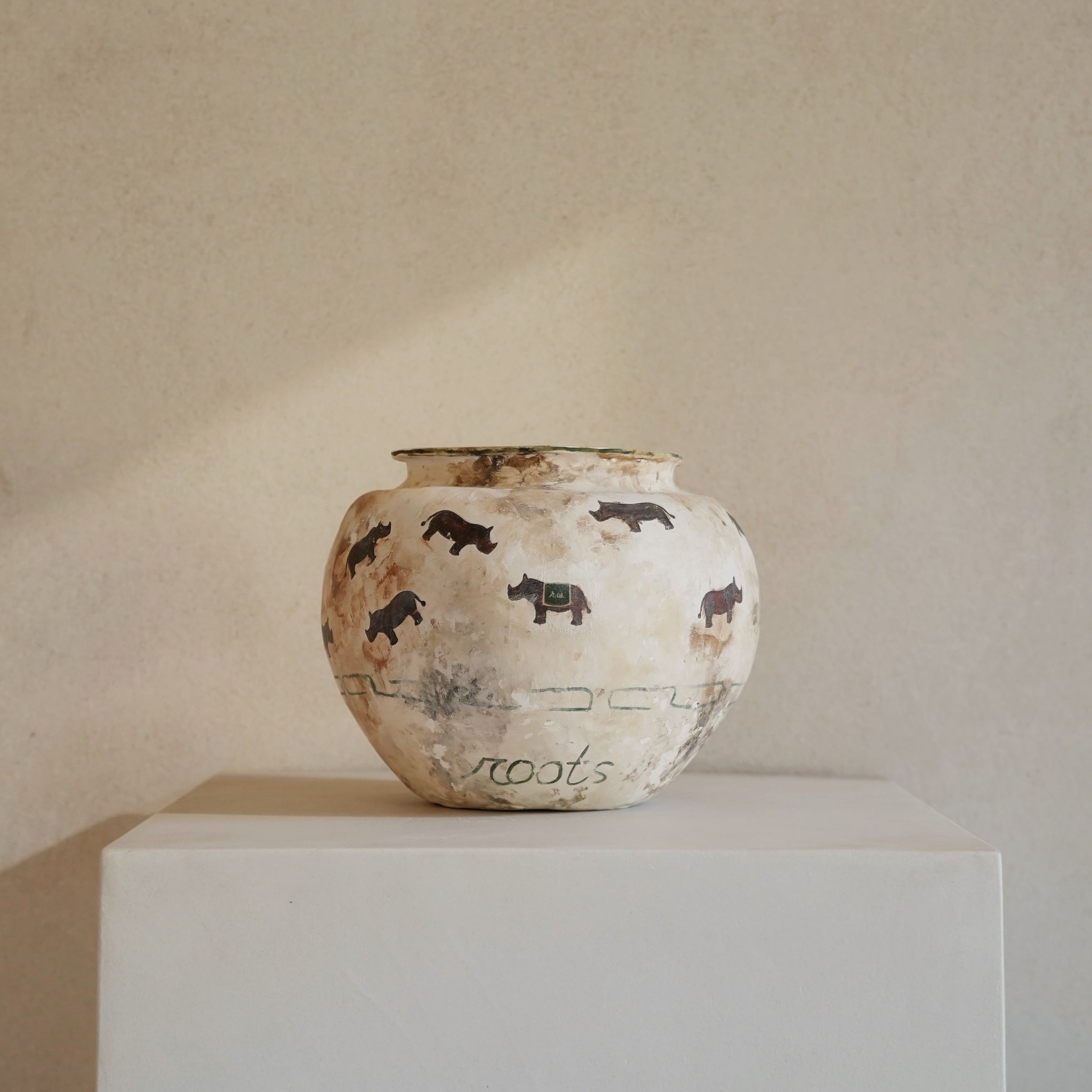 Hand-crafted from natural clays and plaster with drawings of baby rhinos.