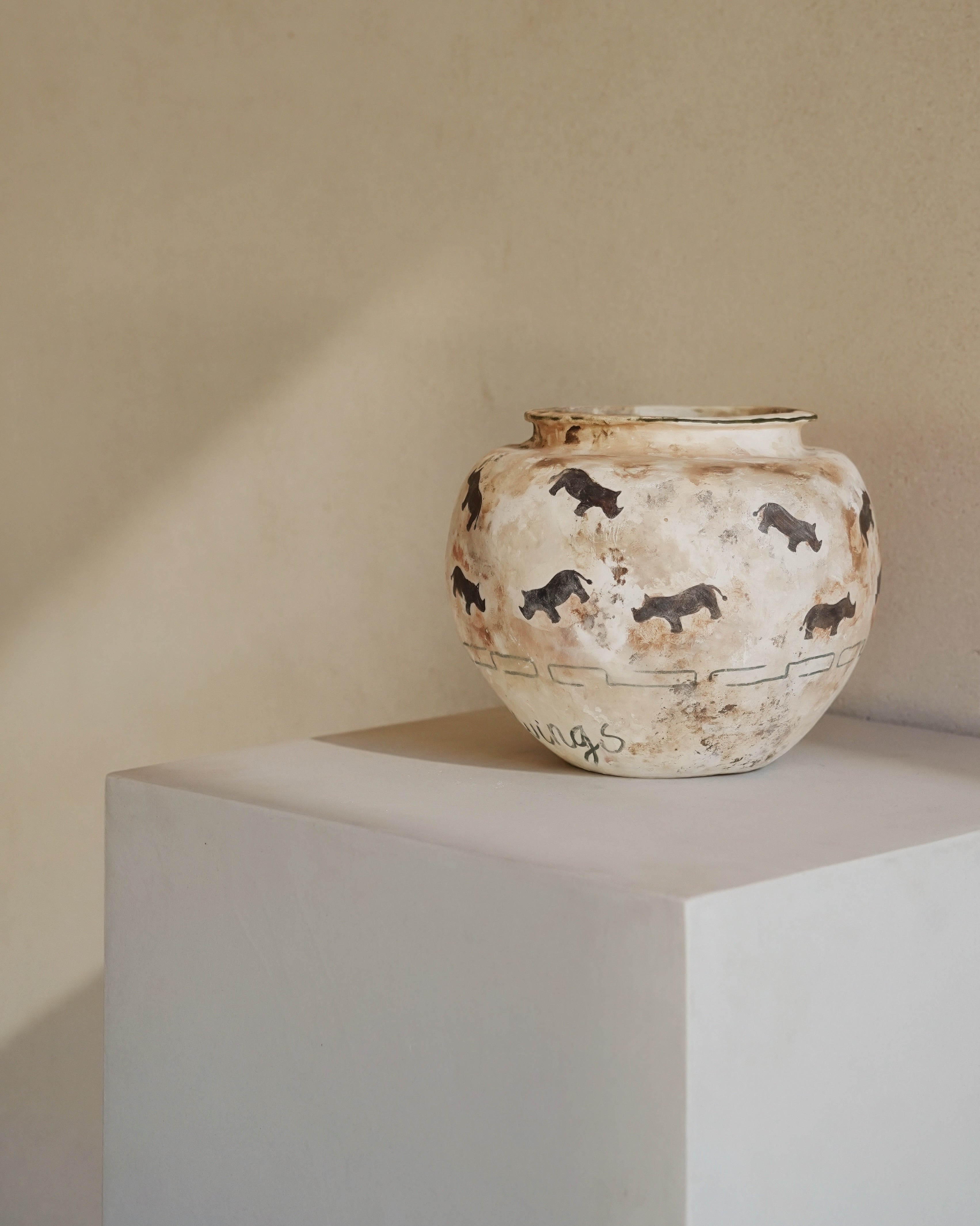 Hand-crafted from natural clays and plaster with drawings of baby rhinos.