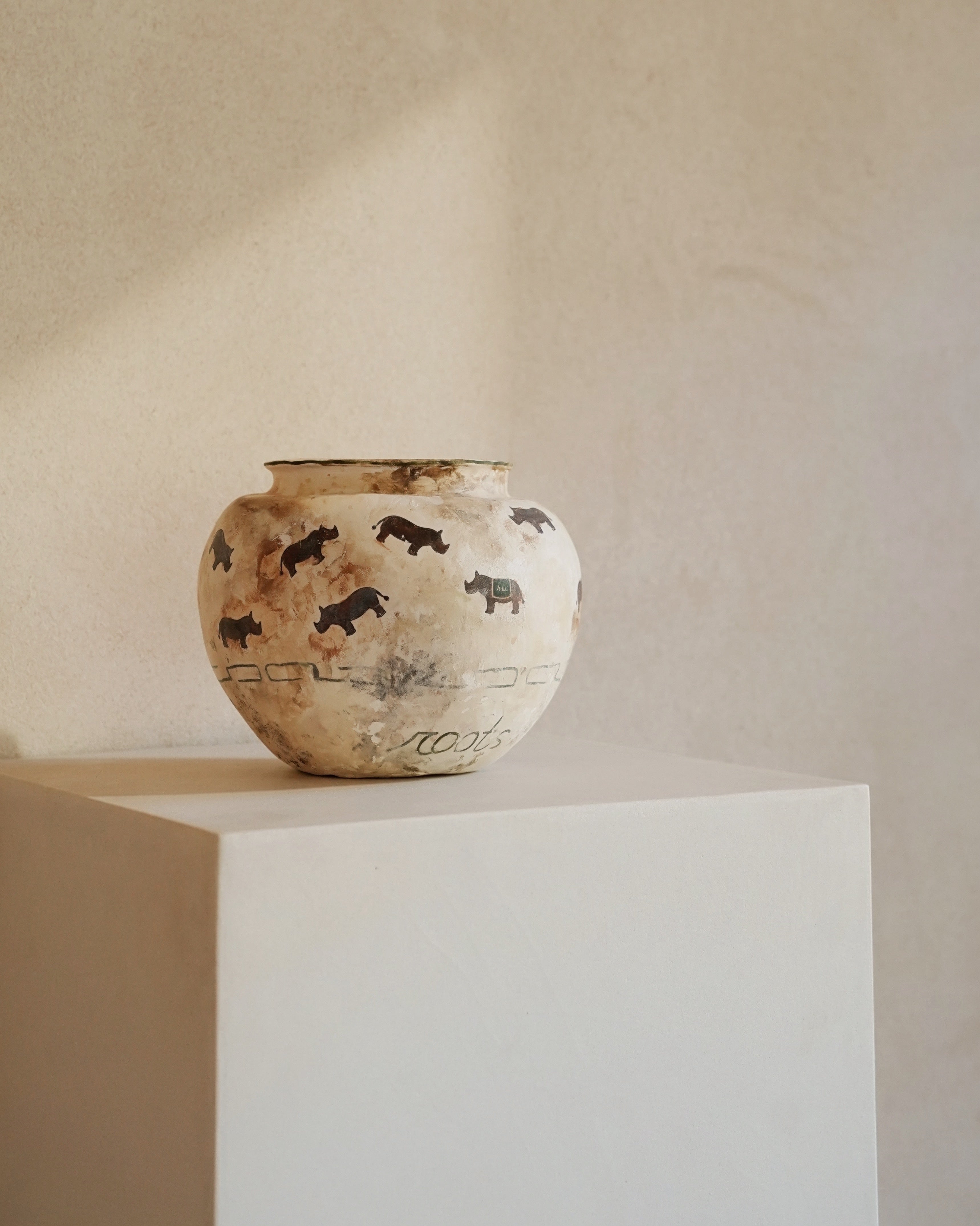 Hand-crafted from natural clays and plaster with drawings of baby rhinos.