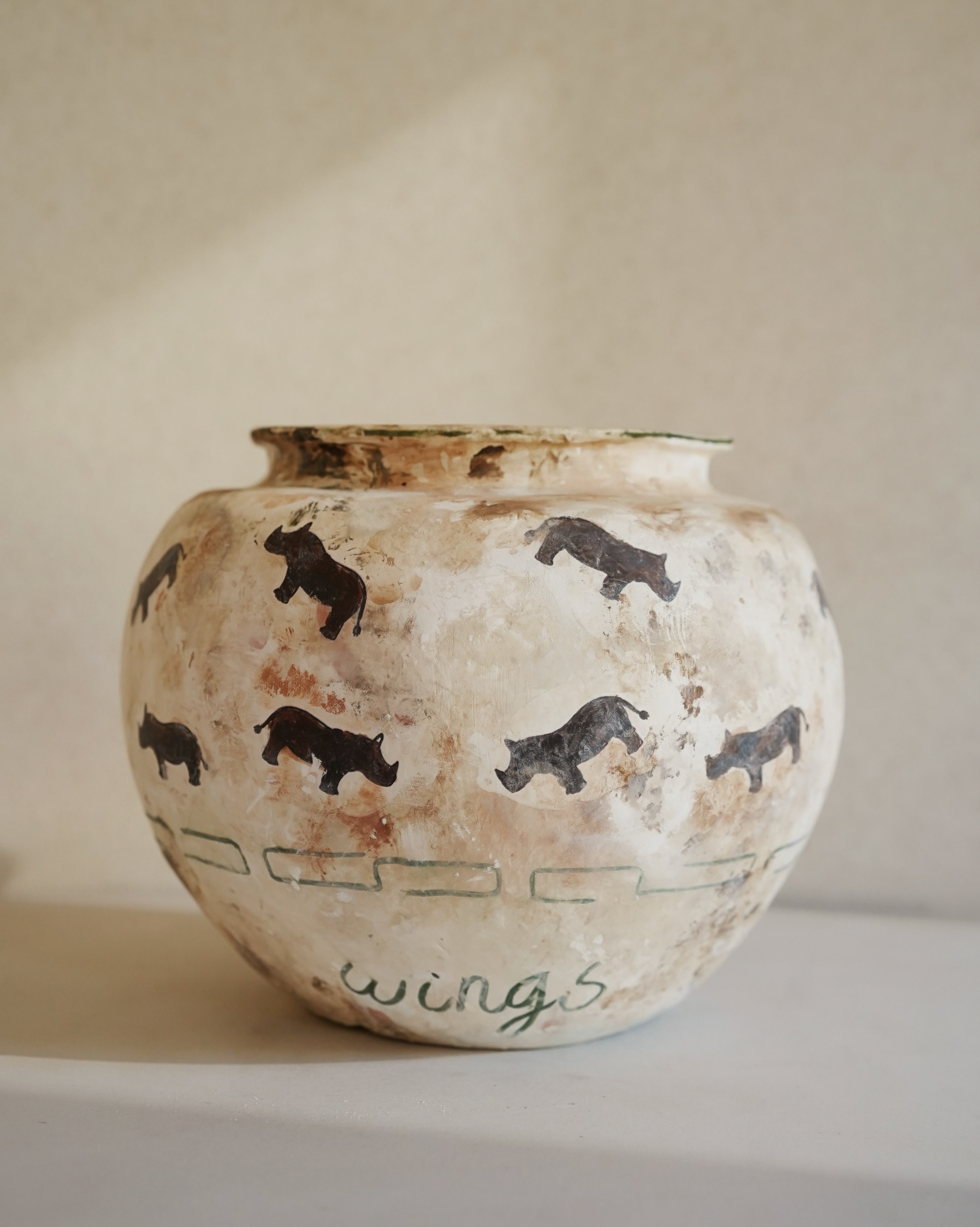 Hand-crafted from natural clays and plaster with drawings of baby rhinos.