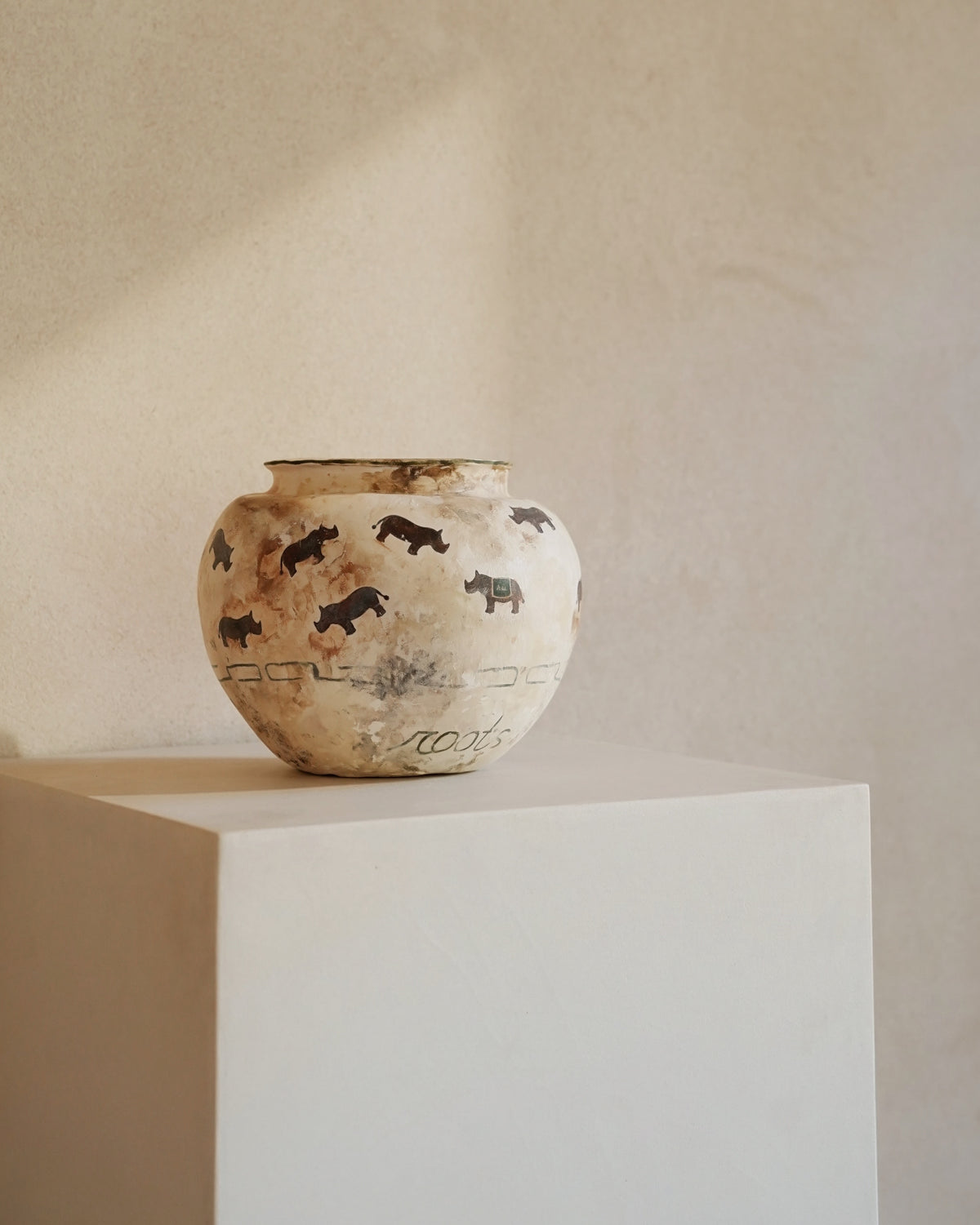 Hand-crafted from natural clays and plaster with drawings of baby rhinos.