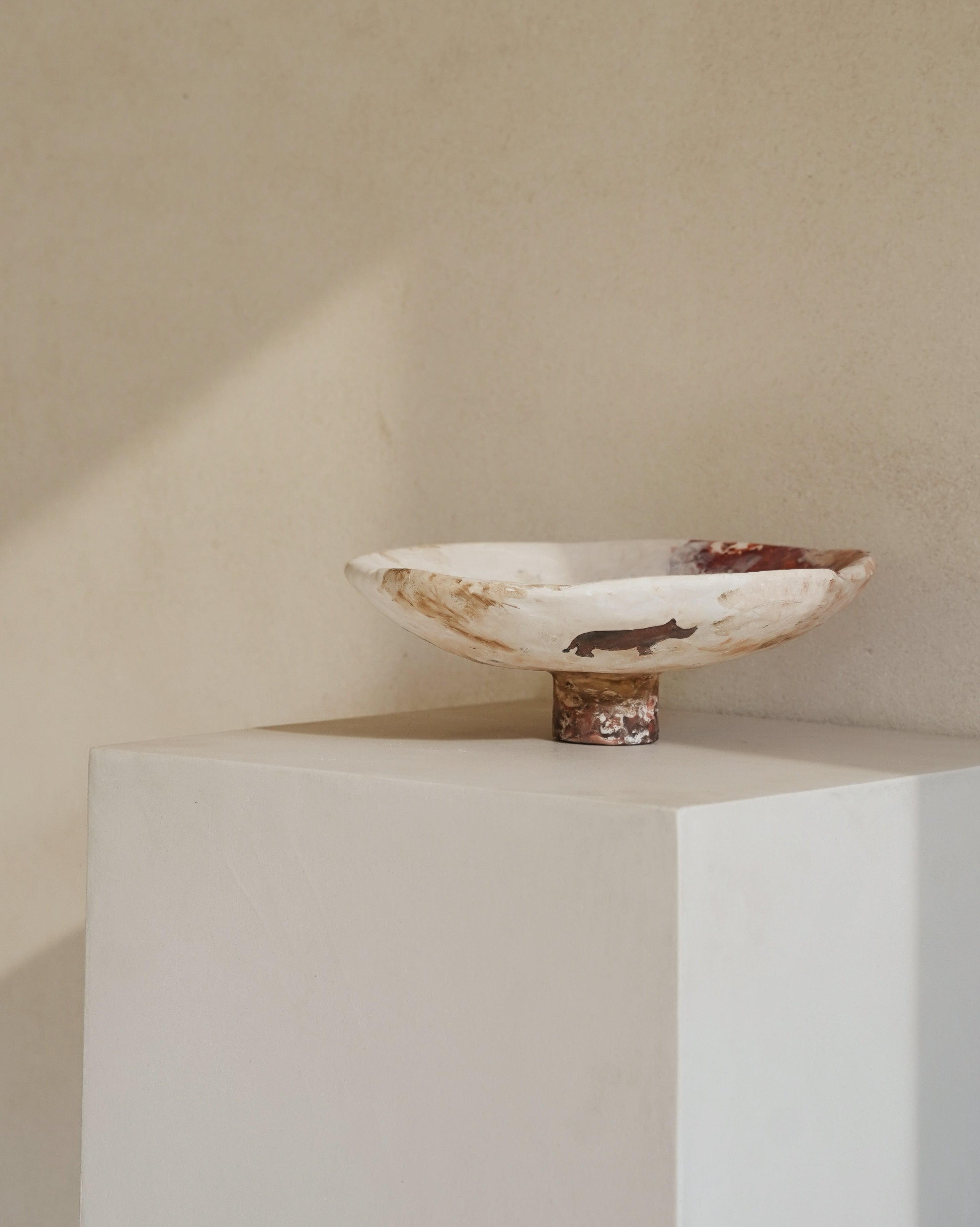 Hand-crafted from natural clays and plaster with drawings of baby rhinos.
