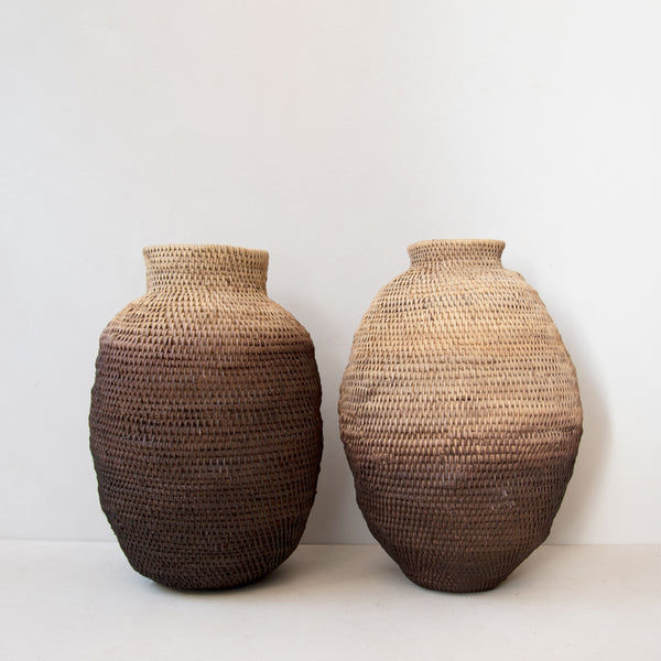 Two hand-woven ombre Buhera baskets alongside one another